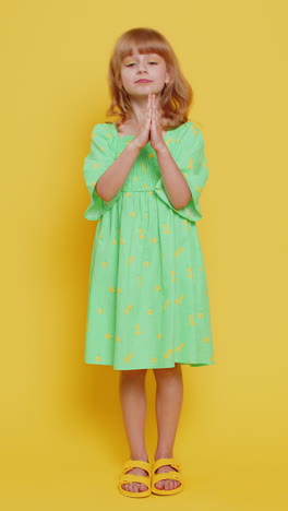 blonde child girl kid praying making wish asking apology help pleading expression looking at camera