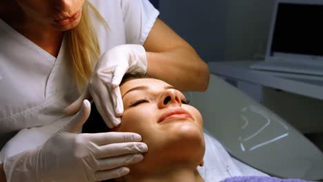 doctor examining female patient skin