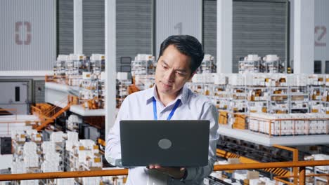 warehouse employee working on laptop