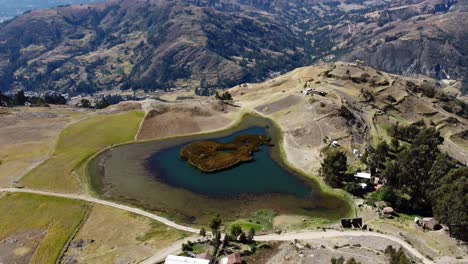 aerial establishing of laguna wilcacocha in huaraz, peru, reflecting the surrounding peaks of cordillera blanca