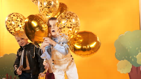 diverse group of kids jumping and having fun. yellow background in studio
