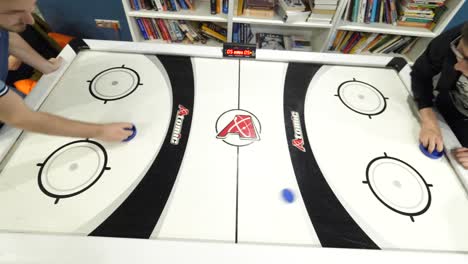 two men playing air hockey