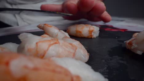 chef takes a fresh shrimp to prepare cebiche