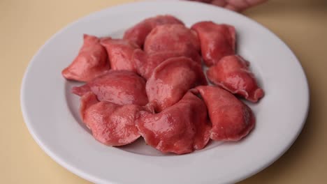 plate of pink pierogi