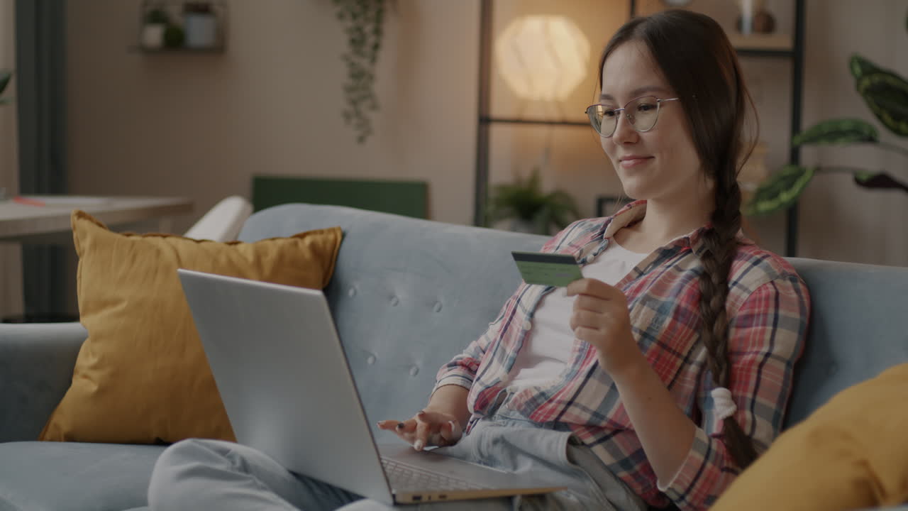 Woman Shopping Online with Credit Card on Laptop