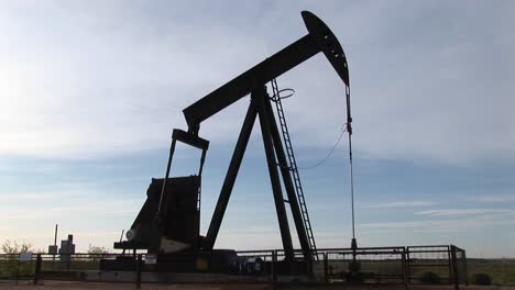 medium shot of an oil pump turning in the new mexico desert