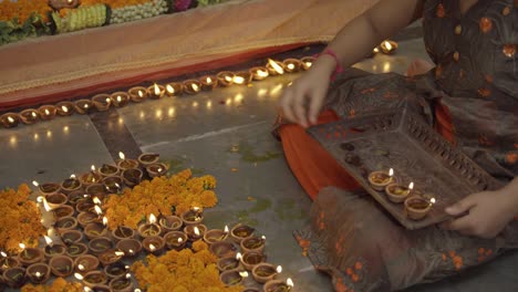 indian girl lighting diyas