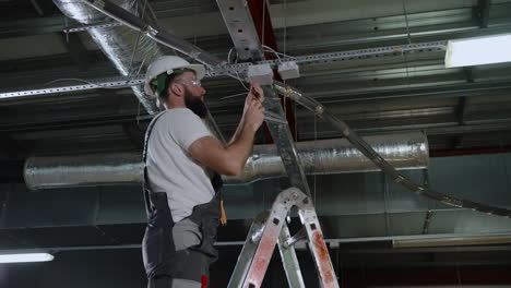 electrician installing ceiling lights