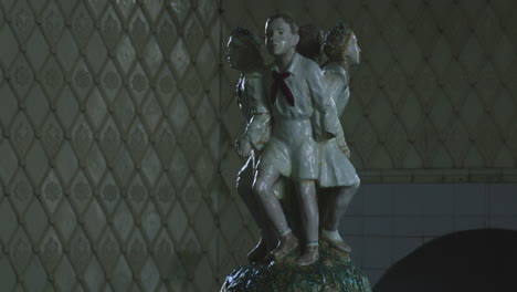 soviet children pioneers porcelain statue in ornate spa room, georgia