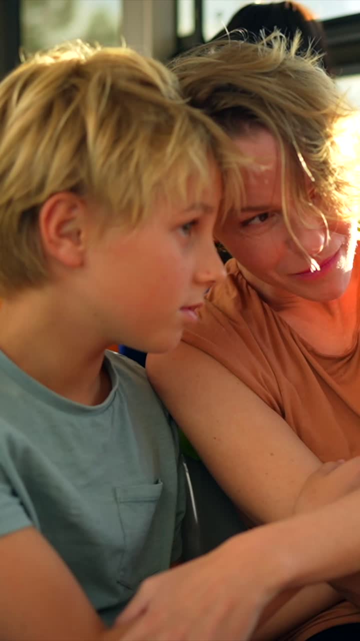 A mother and son by a window