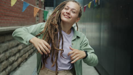 happy woman with dreadlocks in the city