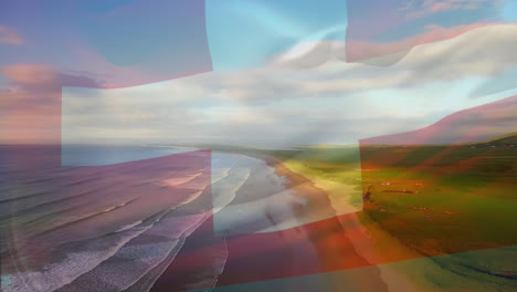 digital composition of waving switzerland flag against aerial view of the beach