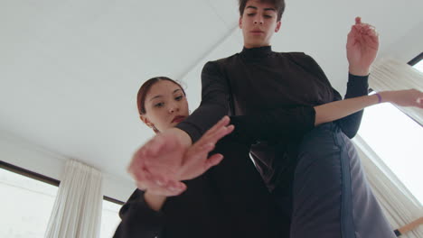 low angle view of contemporary dance performed by young couple