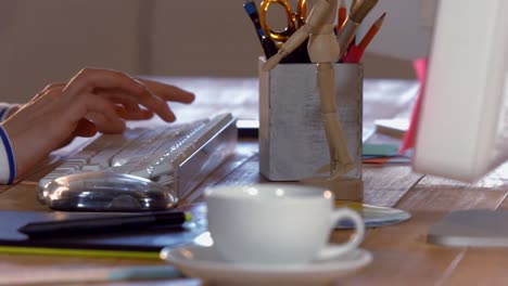 Hands-of-casual-businesswoman-using-computer