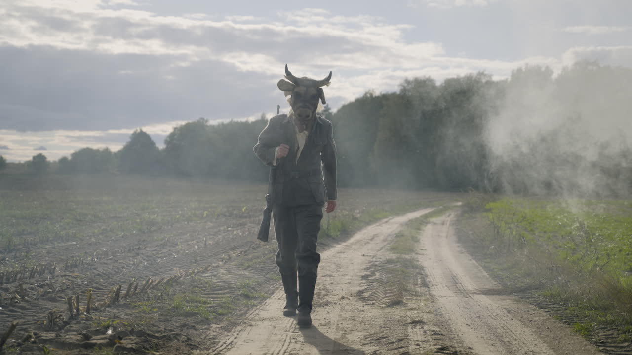 Soldier in a Cow Mask on a Dusty Road