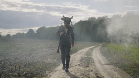 soldier in a cow mask on a dusty road