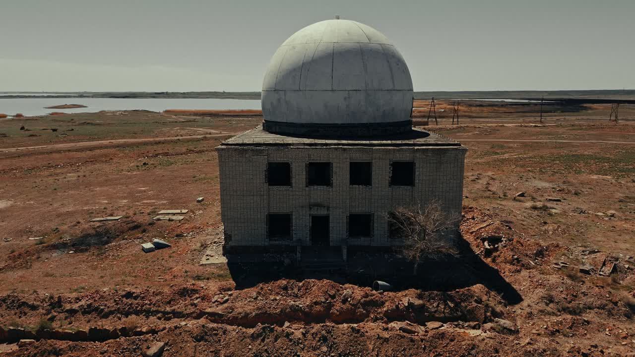 Abandoned Radar Station with Dome in Desolate Arid Landscape