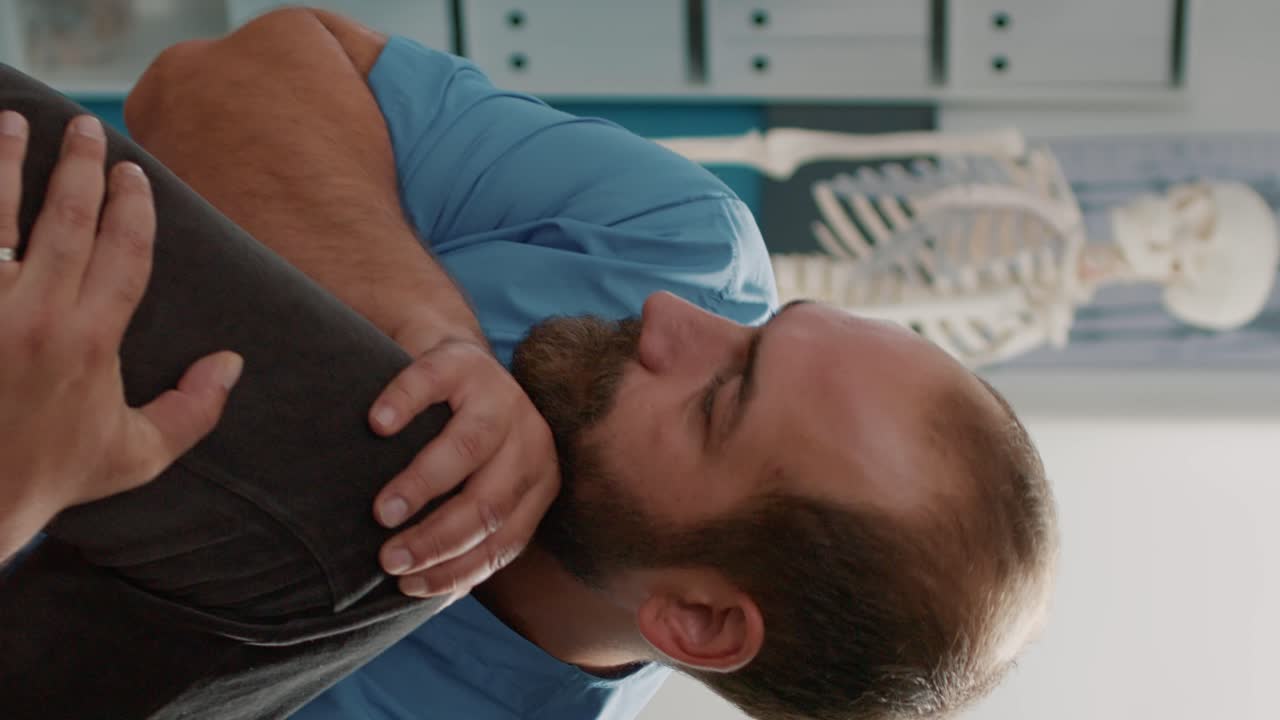 Medical assistant helping old woman with muscles stretching