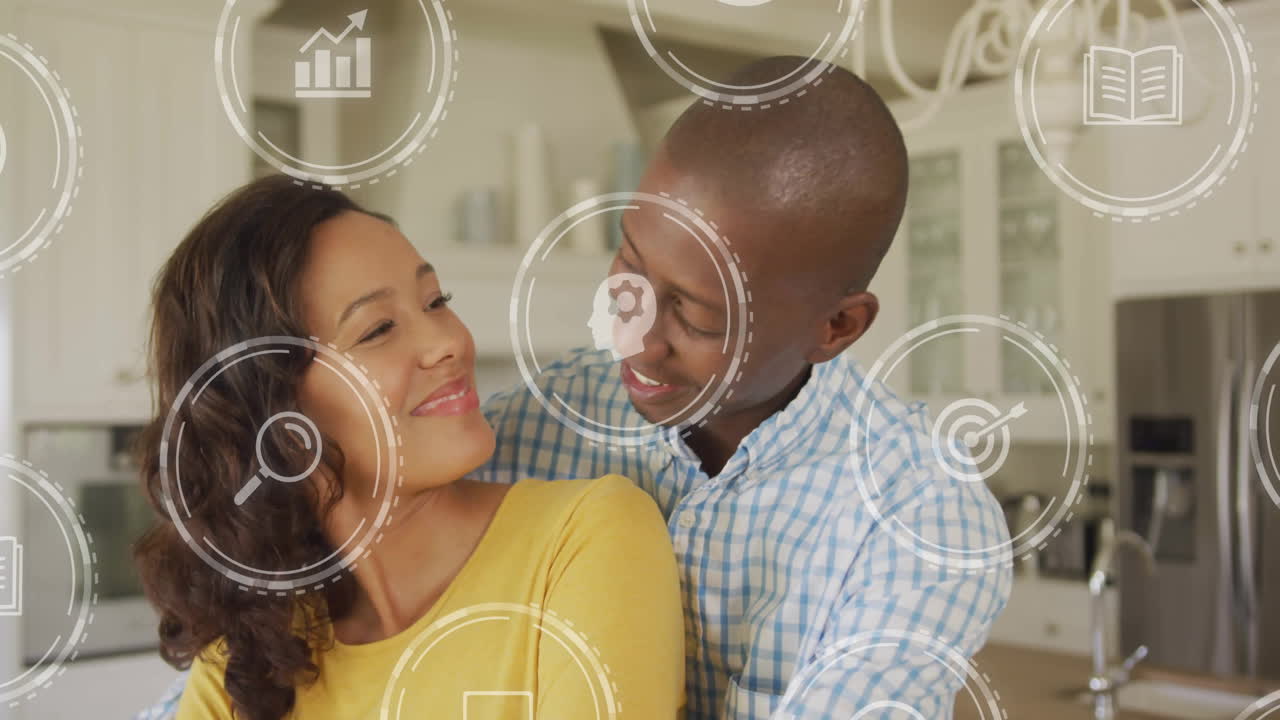 woman leaning behind man, smiling in kitchen, while finance chart and target icons floating