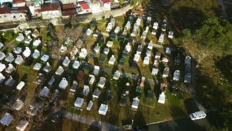 Aerial-view-around-sunlit-graves-at-the-Manila-memorial-park,-in-the-Philippines