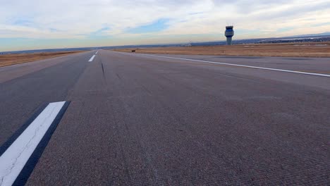 airplane view of the runway, control tower and water towers at the rocky mountain metropolitan airport