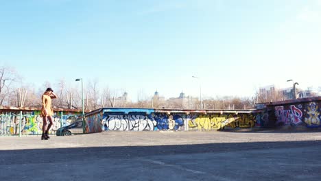 woman walking on a rooftop with graffiti