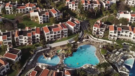 real-estate-in-canary-island-Spain-drone-fly-above-fuerteventura-revealing-resort-with-swimming-pool