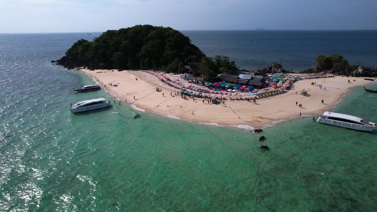 Aerial View of a Tropical Island Beach with Tourists