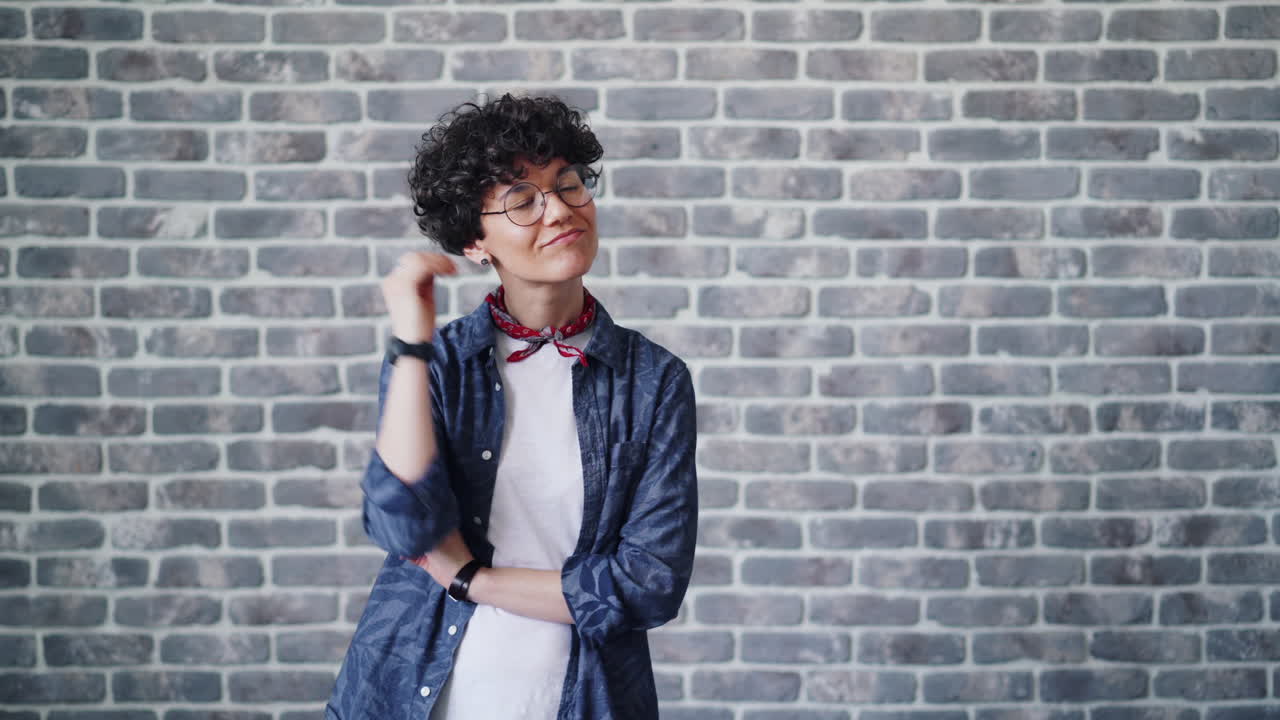 Thoughtful Woman in Front of Brick Wall
