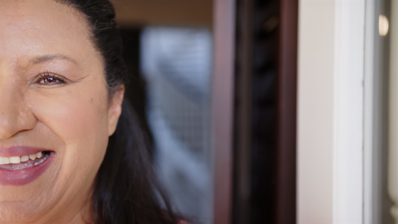 Smiling mature woman with dark hair, close-up portrait, showing natural expression, copy space