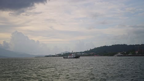 the ocean stretches endlessly as small ships glide across the waves, their sails catching the breeze under the open sky.