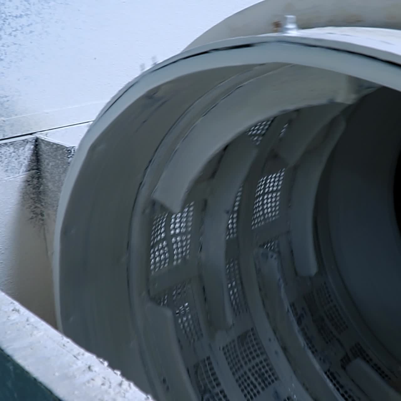 White kaolin clay mixed up with water being filtered at the factory. Up-to-date kaolin industry manufacturing