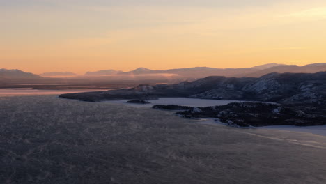 lake fog - fog over the lake laberge at sunrise in winter in yukon, canada. - aerial shot