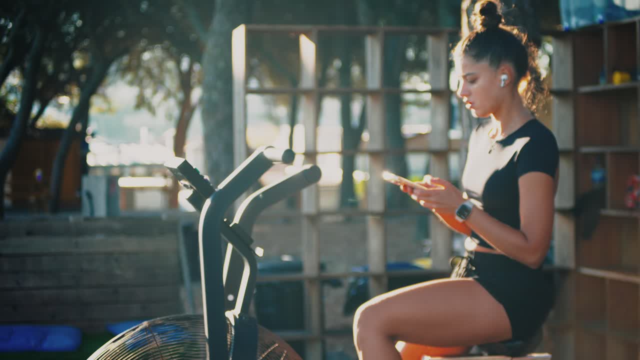 Woman Exercising on Air Bike Outdoors