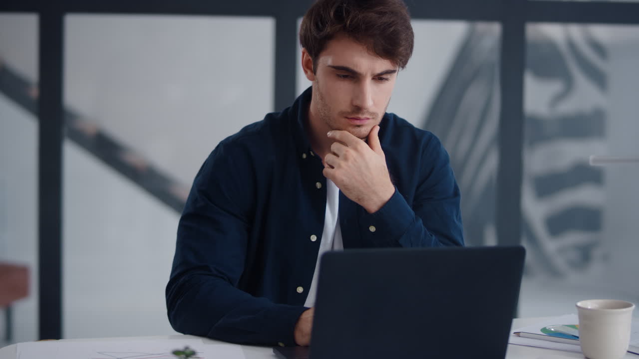 Close-up view of focused business man working laptop in office