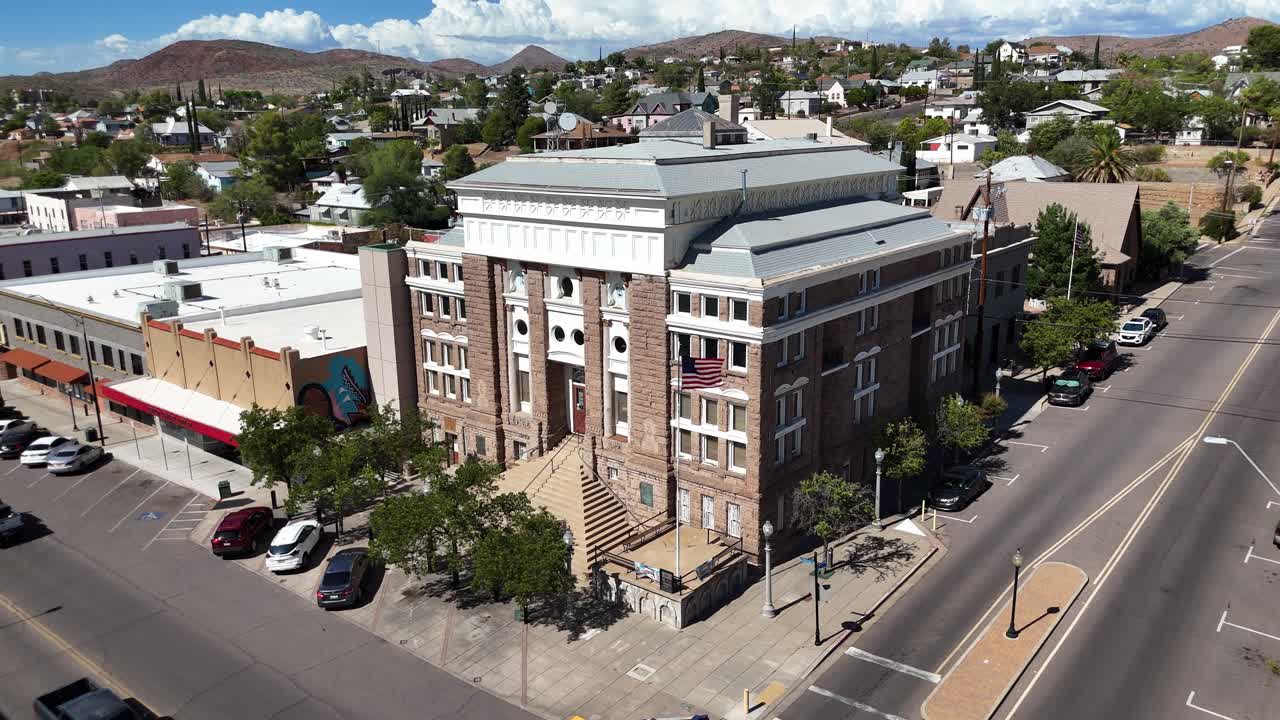 Courthouse in Downtown Globe, Arizona. Cars Driving Down Street, American Flag Blowing in Wind, Partly cloudy day in Late July, Aerial View