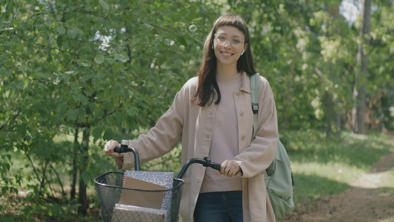 Young Woman with Bicycle in Park