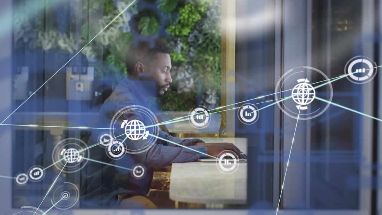 Animation of network of connected icons with businessman at desk using laptop