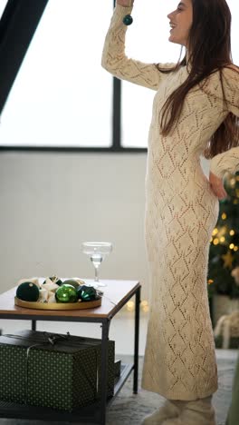 woman decorating christmas tree and presents