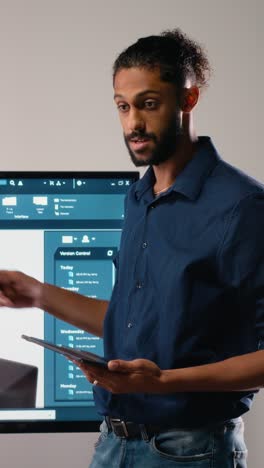 vertical video middle eastern urban developer presenting blueprints master plan to colleagues