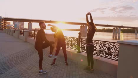 group stretching session at sunrise by the river
