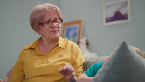 kind grandmother with glasses reads a book