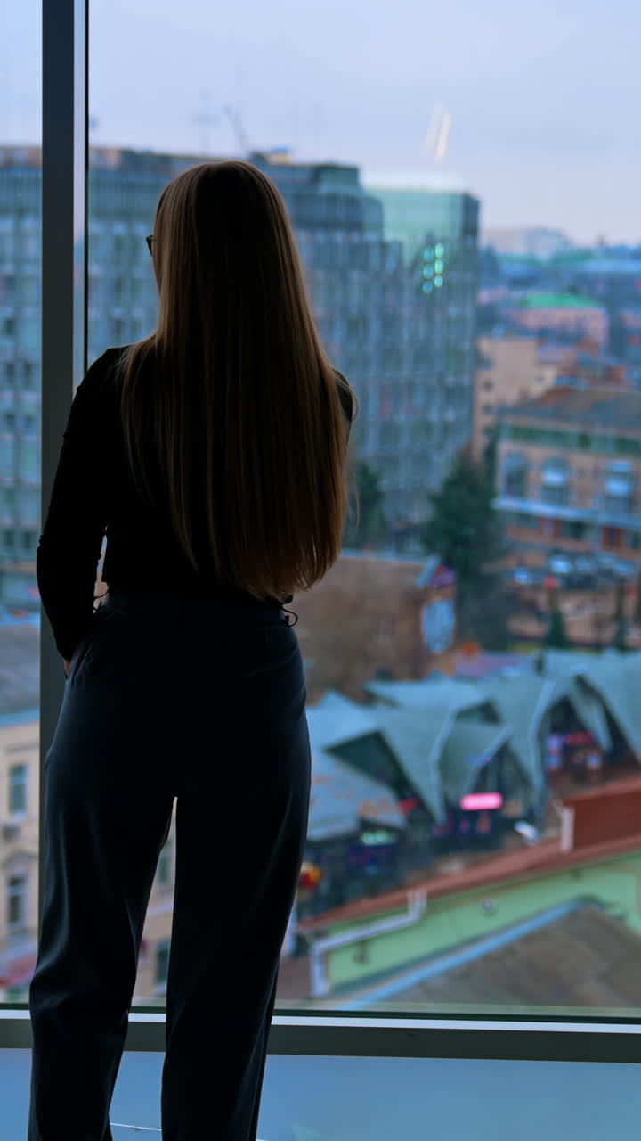 Attractive businesswoman in eyeglasses talking on cellphone. Vertical video