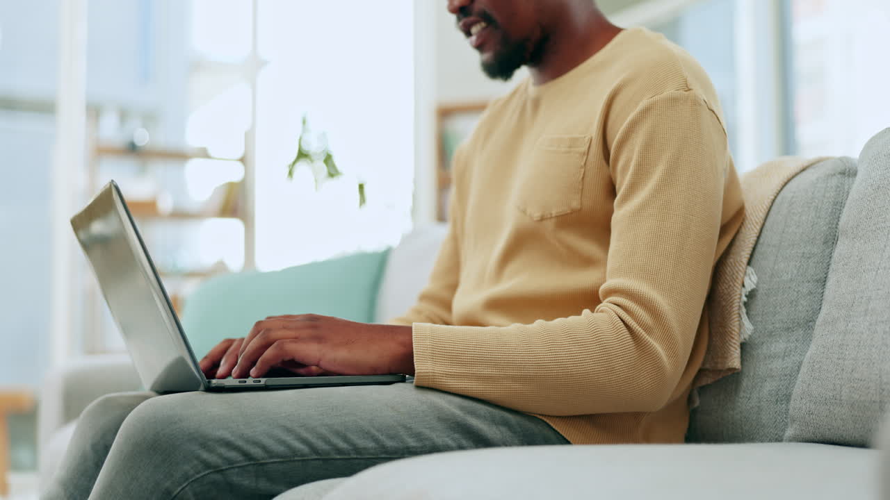 Typing, laptop keyboard and hands of man on sofa