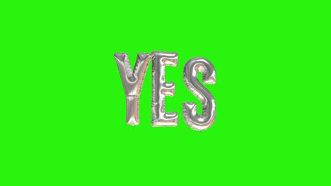 silver word yes floating foil balloons on green screen