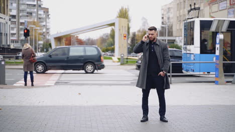 professional businessman using mobile phone. young businessman talking on smart phone on street