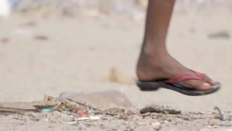 kid-runing-in-polluted-Carter-road-beach-legs-and-foot-closeup-view-mumbai-india