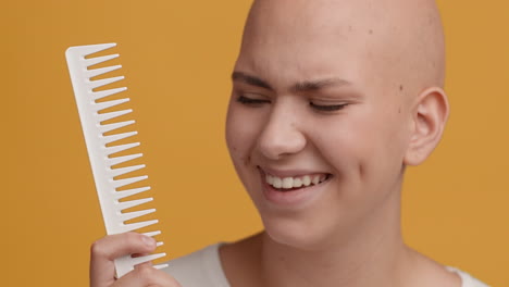woman with bald head and comb