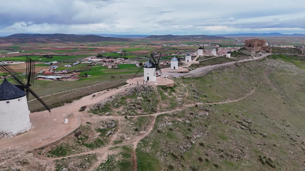 Drone video of Consuegra windmills and castle on hill
