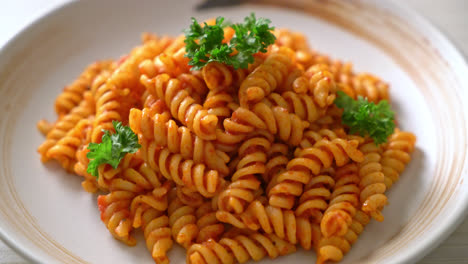 spiral or spirali pasta with tomato sauce and parsley - italian food style